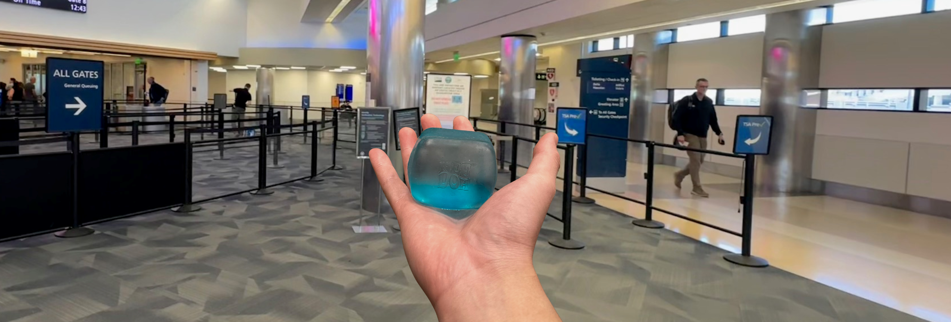 Hand holding a NeeDoh sensory toy at SJC security checkpoint