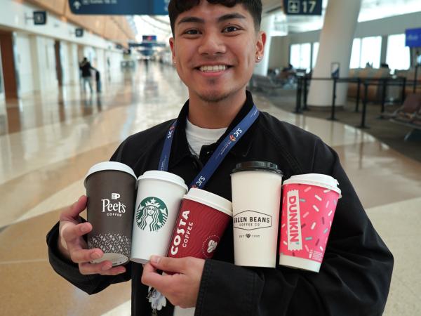 SJC Employee holding five coffee cups