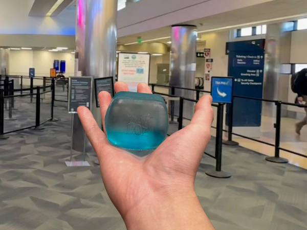 Hand holding NeeDoh sensory toy at SJC security checkpoint