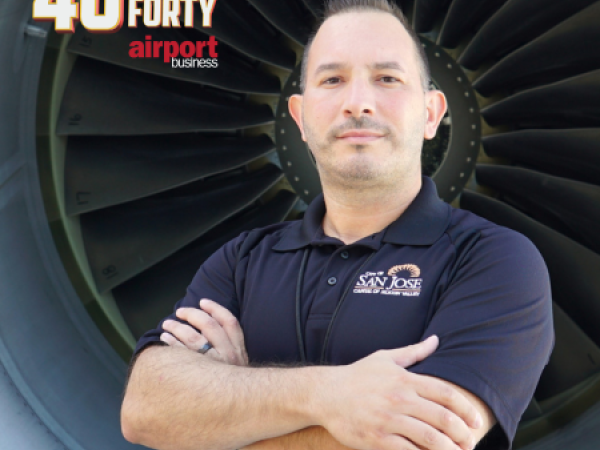 Headshot of Chris Fernandez in front of an airplane engine.