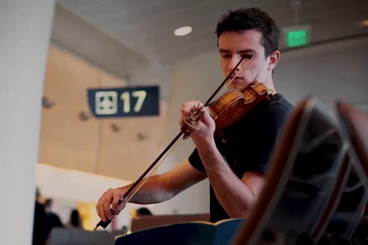 Ben and his violin at gate 17
