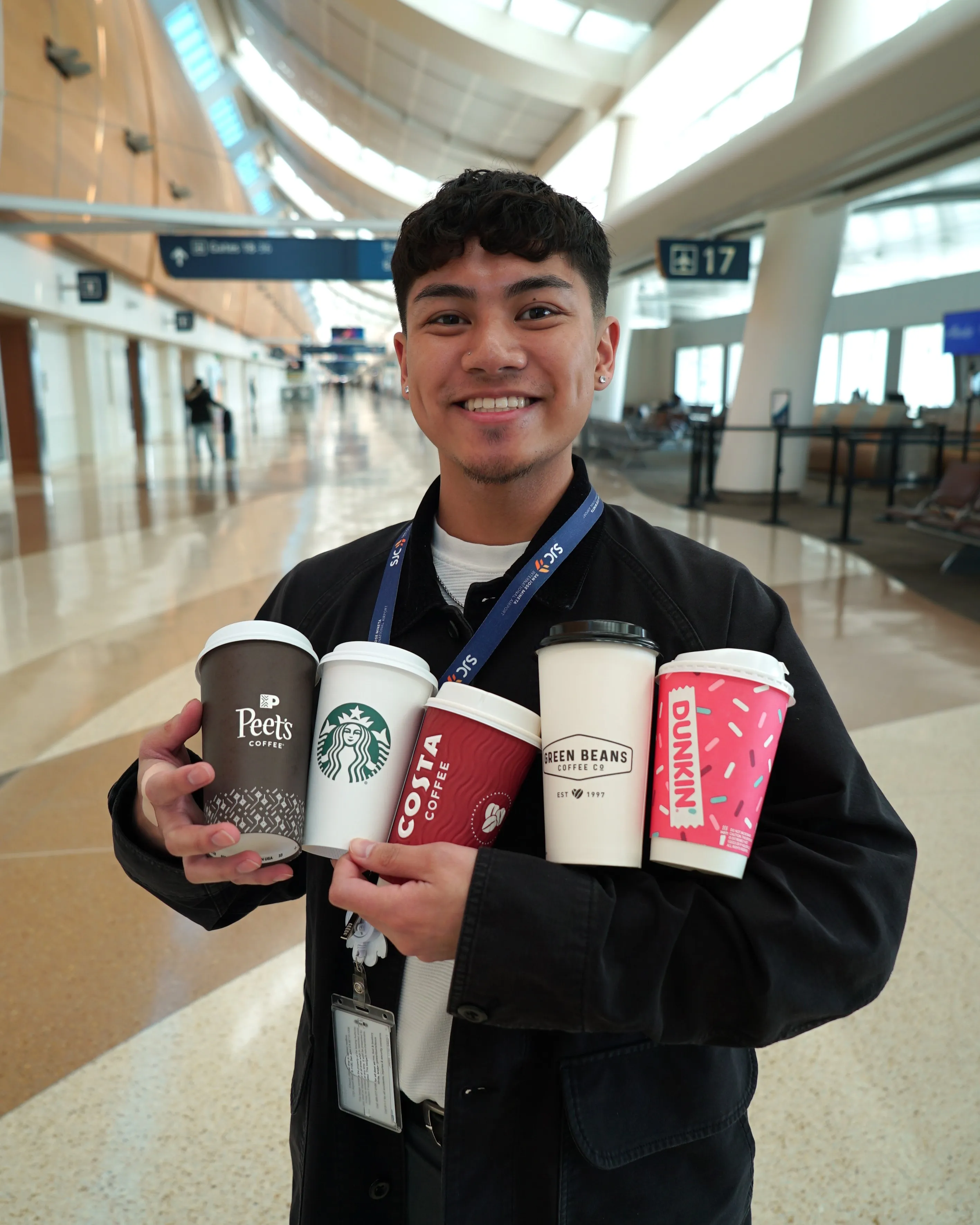 SJC Employee holding five coffee cups