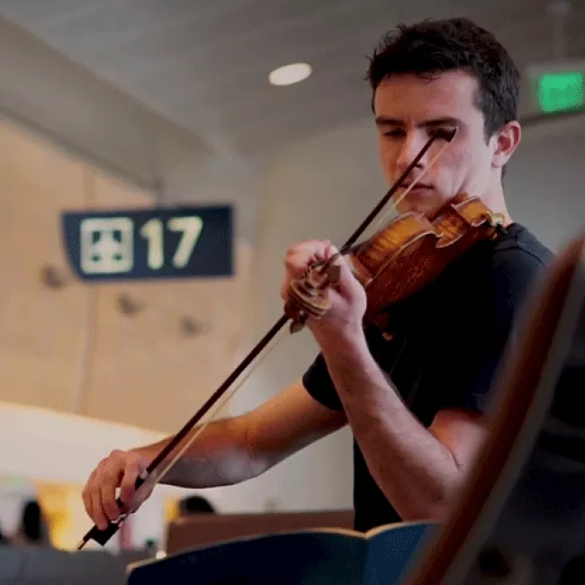 Image of Ben and his violin at gate 17