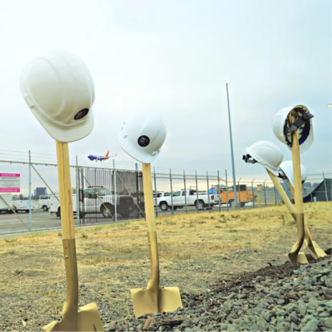 Image of Shovels and helmets at groundbreaking ceremony.